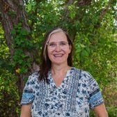 jill robbins smiles in front of a tree