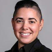 Natalie Musumeci's face on a gray background